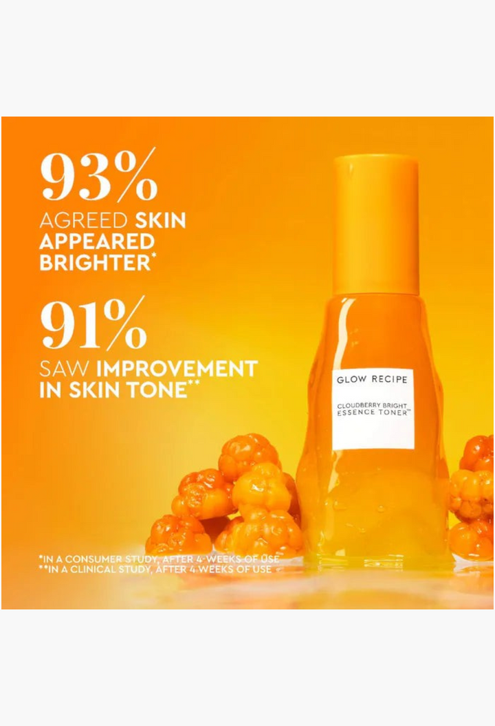 GLAM MODA Glow Recipe Cloudberry Bright Essence Toner bottle surrounded by fresh cloudberries on a bright orange background