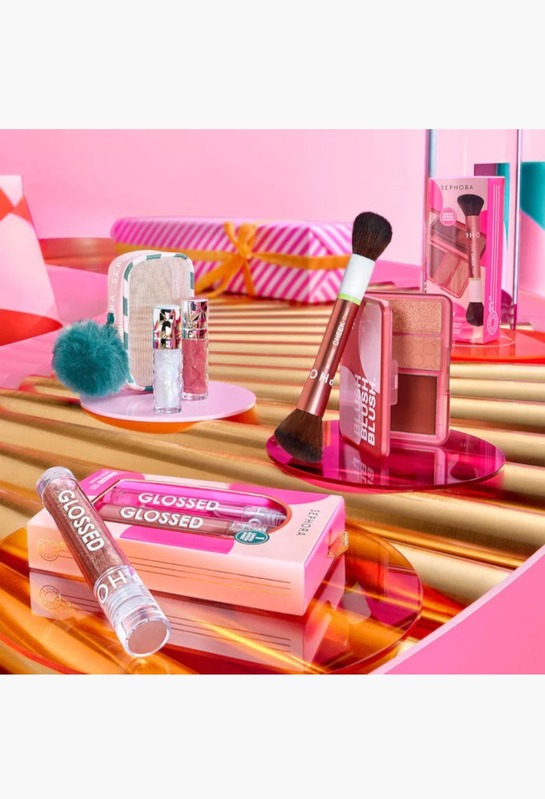 GLAM MODA Outrageous Lip Plumper duo set with shimmering glosses and a festive gold-threaded pouch for holiday gifting