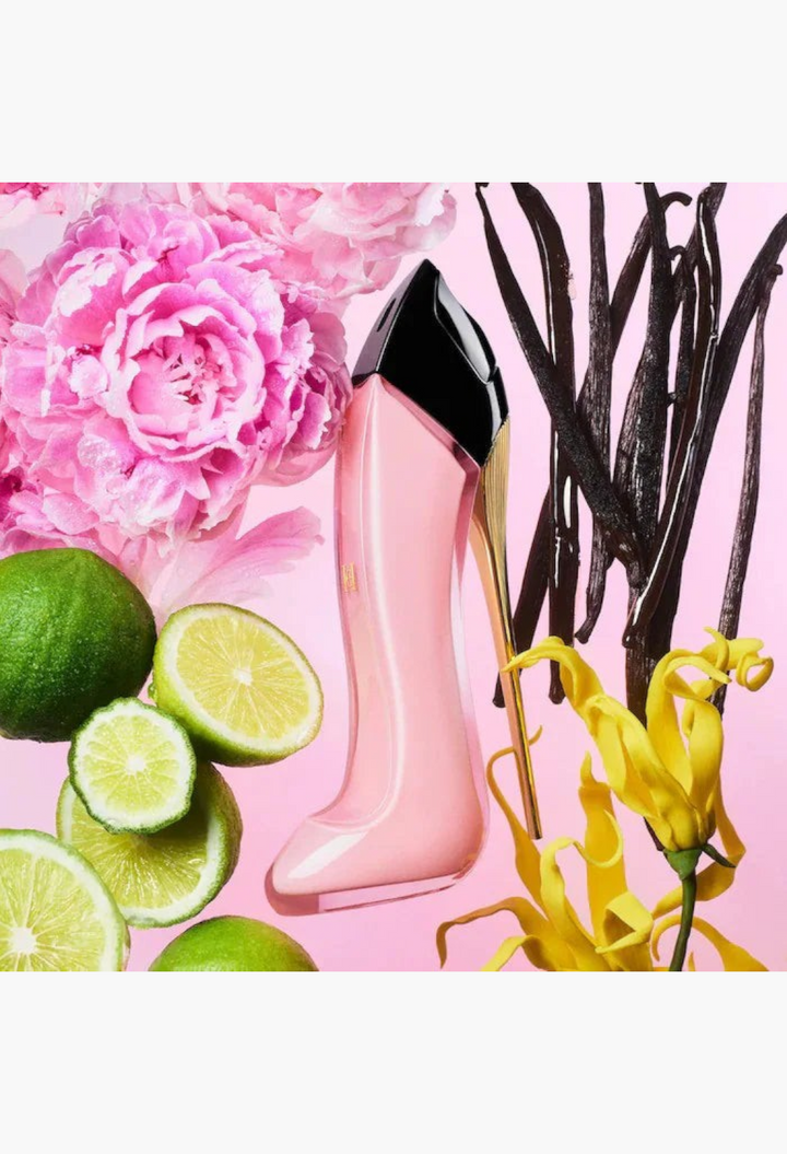 GLAM MODA perfume bottle shaped like a pink stiletto heel surrounded by fresh lime slices, pink peonies, and vanilla beans.