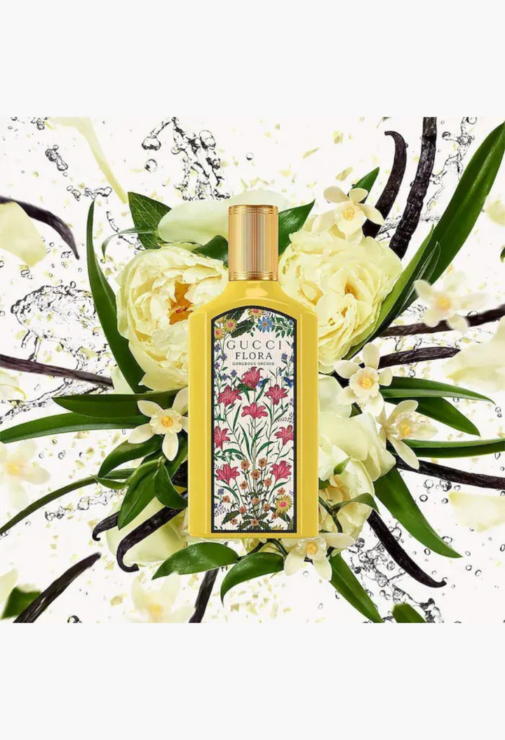GLAM MODA Gucci Flora Gorgeous Orchid perfume bottle surrounded by yellow flowers and vanilla bean accents
