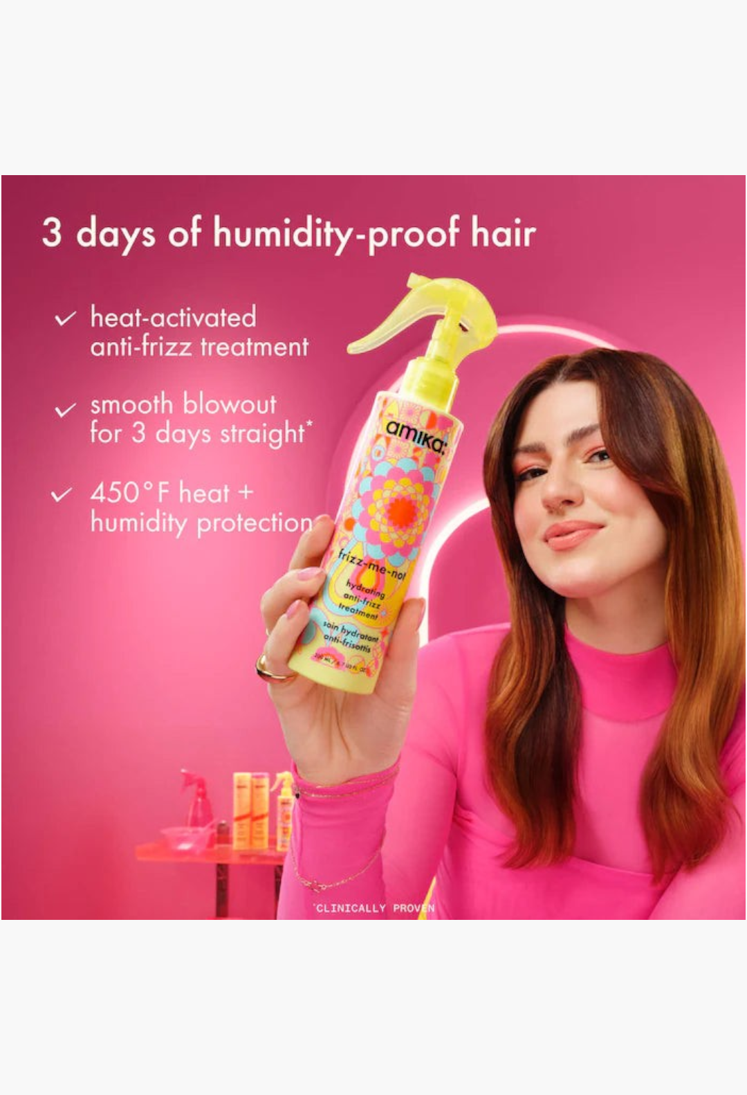 GLAM MODA model holding Amika Frizz Me-Not anti-frizz spray against a pink background with product benefits listed
