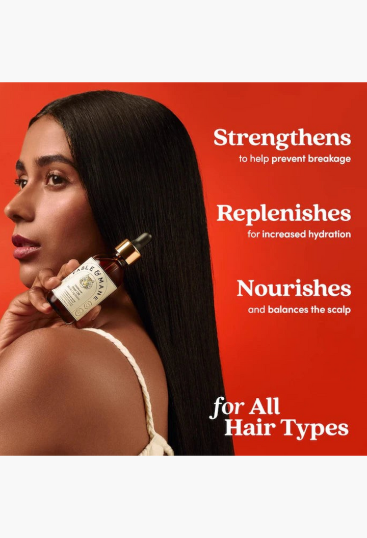 GLAM MODA model with long straight dark hair holding a Fable & Mane HoliRoots pre-wash scalp and hair treatment oil