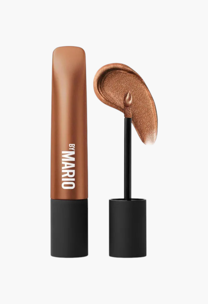 GLAM MODA long-wear cream eyeshadow in a bronze shimmer shade with a doe-foot applicator showing a creamy swatch.