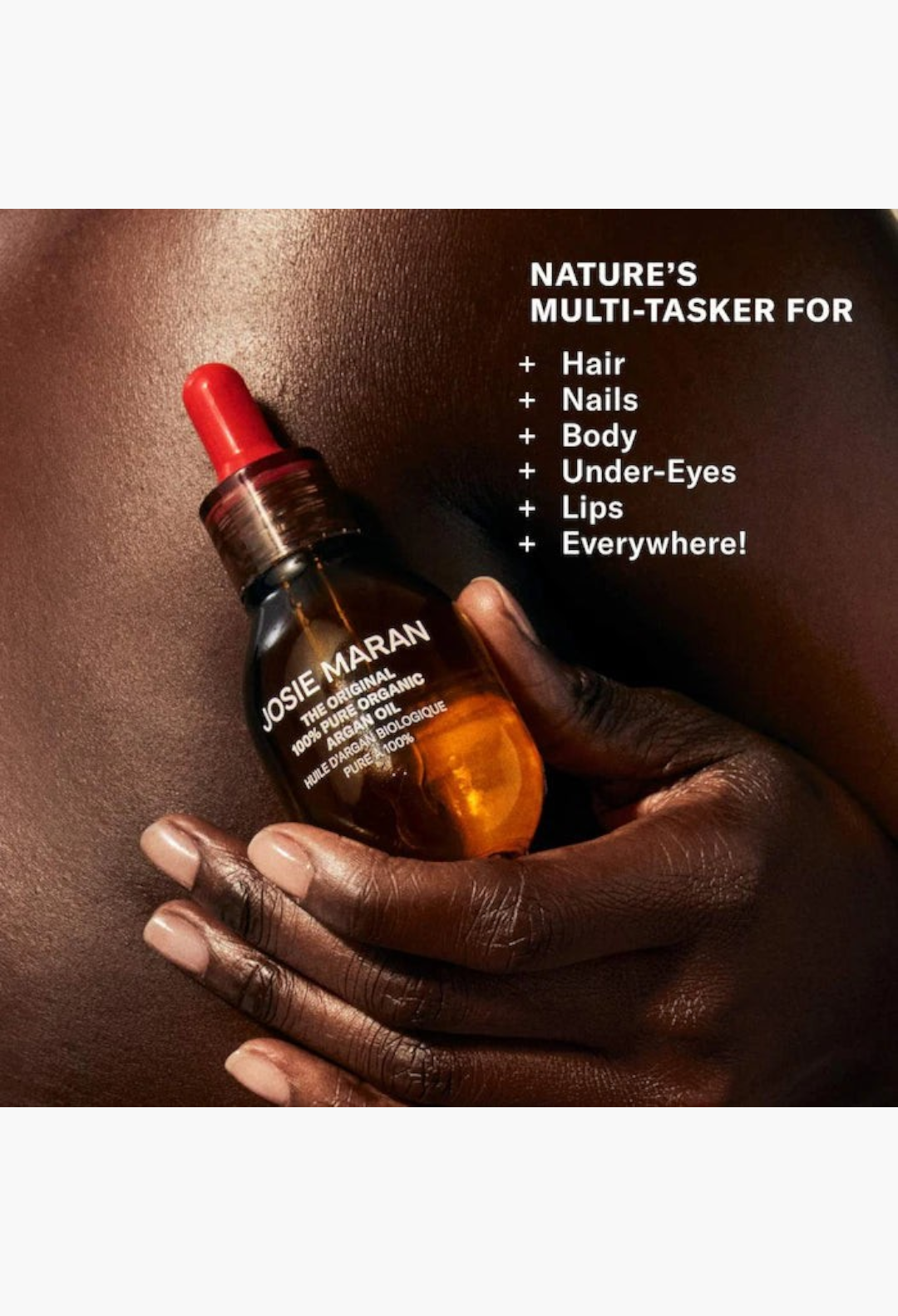 GLAM MODA Hydration Heroes Set featuring Josie Maran 100% Pure Organic Argan Oil held against dark skin