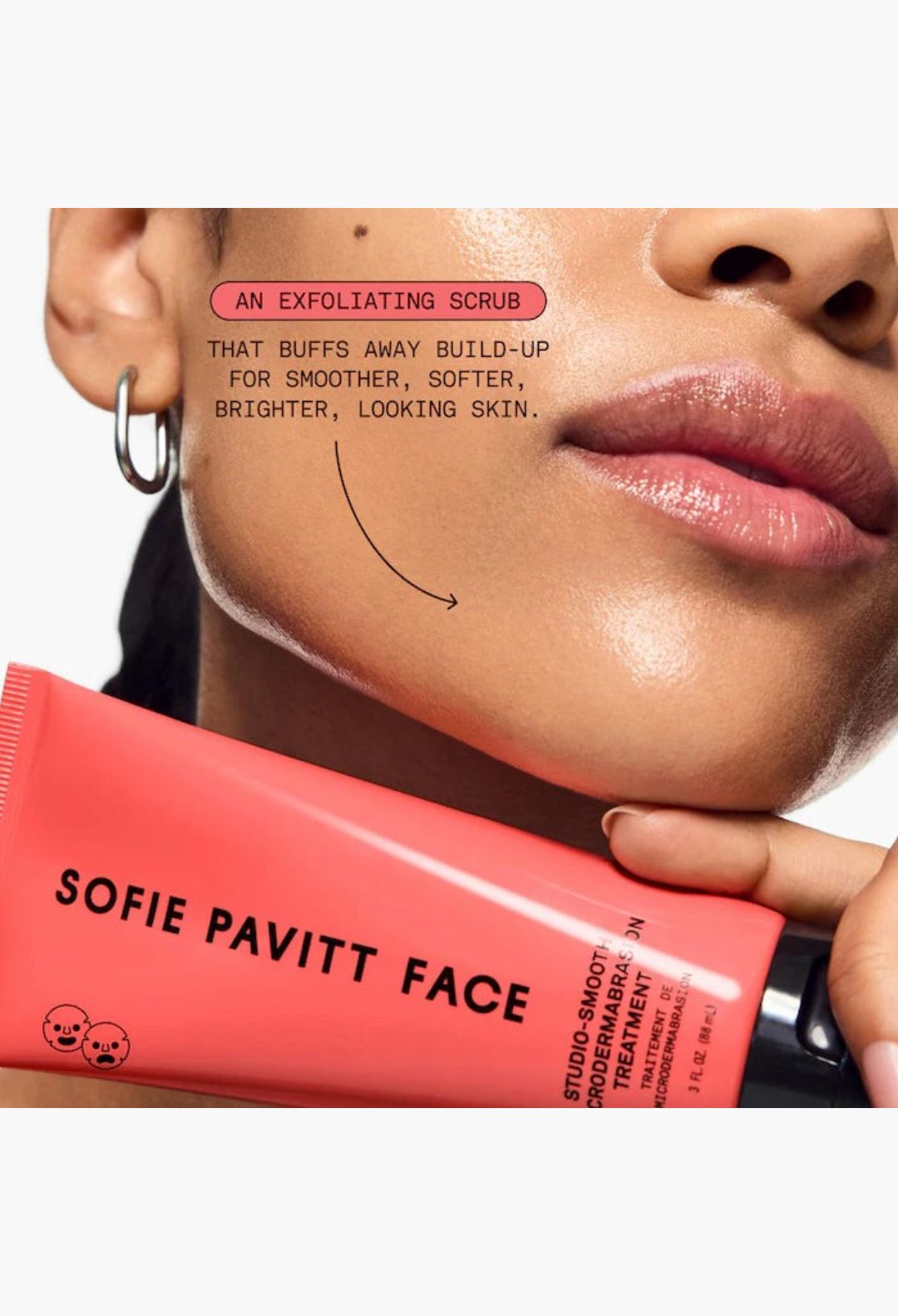 GLAM MODA Studio-Smooth microdermabrasion exfoliating scrub tube held against a model's glowing, smooth cheek.