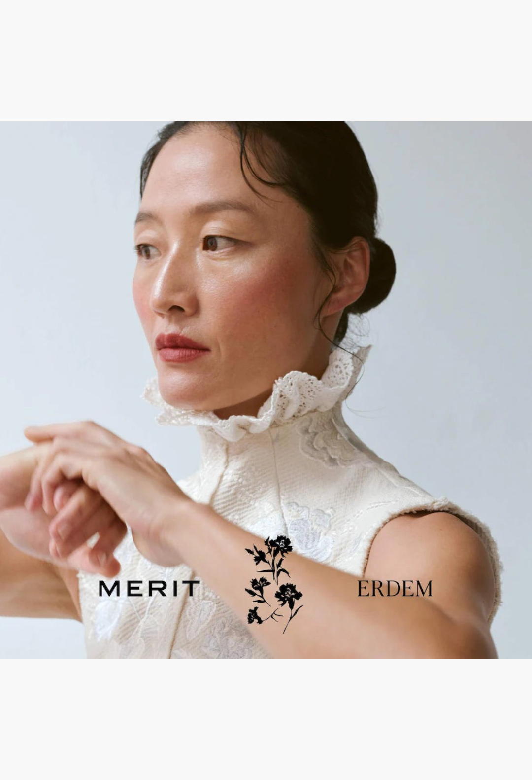 GLAM MODA model wearing MERIT x Erdem Signature Lip lipstick in a soft, elegant look with a high-neck lace top