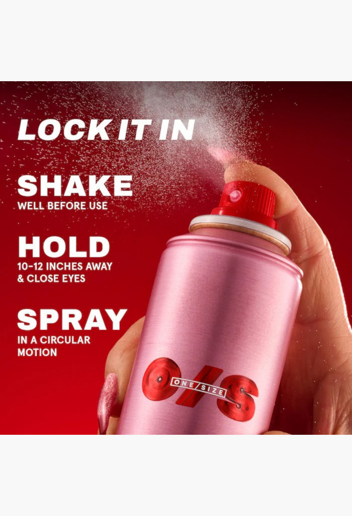 GLAM MODA On 'Til Dawn mattifying waterproof setting spray in a pink aerosol bottle being sprayed by a hand.