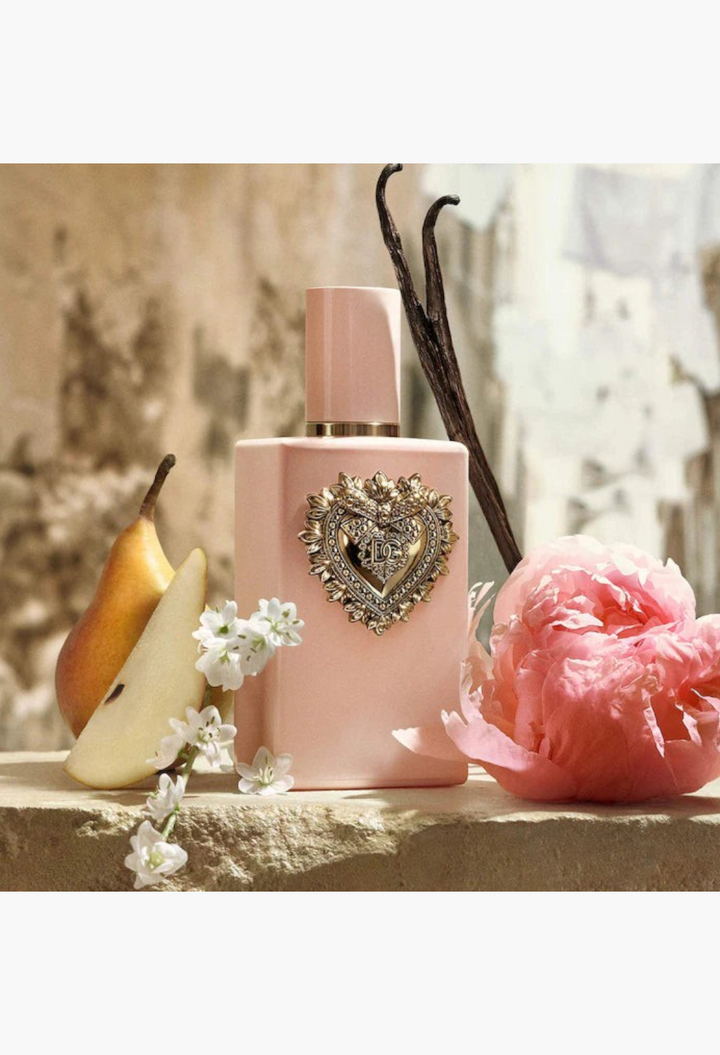 GLAM MODA Dolce and Gabbana My Devotion perfume bottle with pear, vanilla bean, and pink peony flower accents.