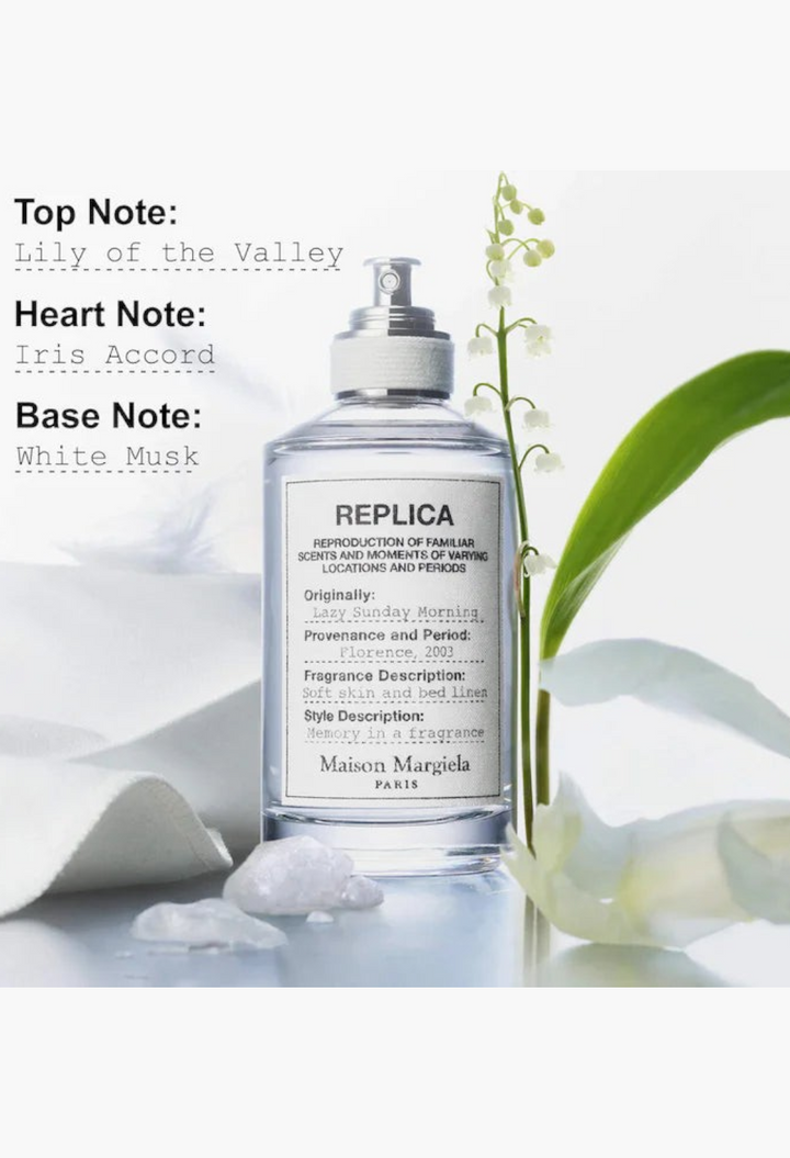 GLAM MODA Maison Margiela Replica Lazy Sunday Morning perfume bottle with lily of the valley flowers and white fabric