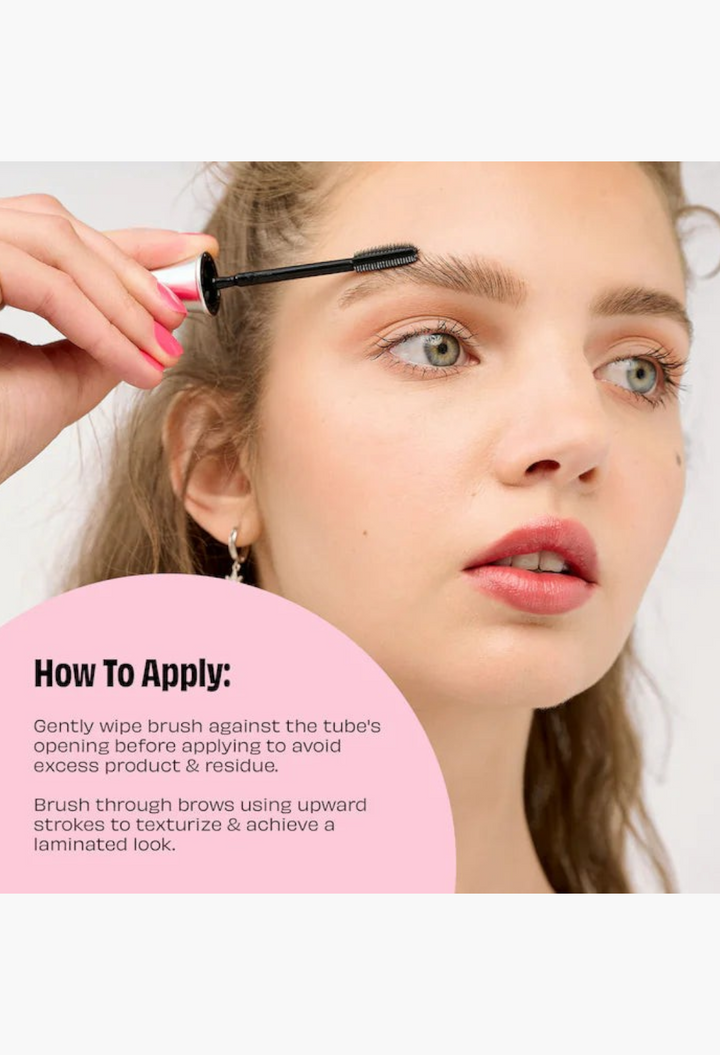 GLAM MODA model applying clear brow gel with a spoolie brush for a laminated brow look